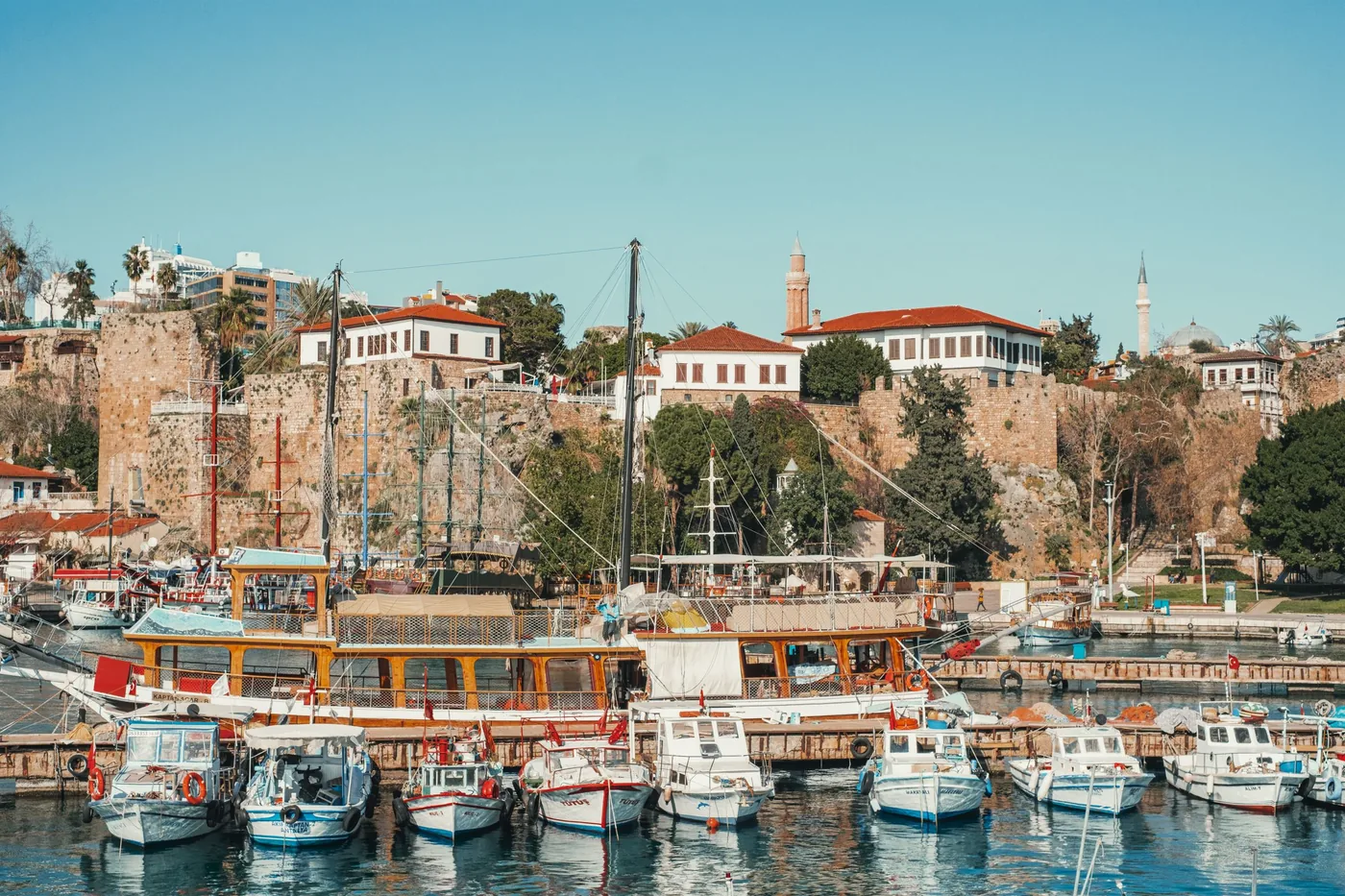 Old harbor of Antalya with fishing boats below the Kaleiçi walls